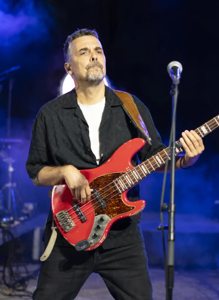 Baixista tocando un baixo vermello no concerto nocturno da Festa do Pemento de Arnoia